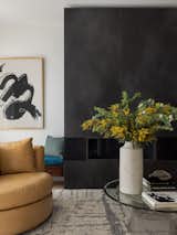 Living Room, Chair, Light Hardwood Floor, and Ribbon Fireplace Staying with the gallery theme, oversized art was installed as a focal point. Curves create more space and allow ease of navigation around the space.   Photo 4 of 5 in Birla Grand Living Room by Alice Chiu