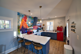 Kitchen, Laminate Counter, Vinyl Floor, Colorful Cabinet, Dishwasher, Range Hood, Refrigerator, Range, Pendant Lighting, Wood Cabinet, Ceiling Lighting, Drop In Sink, and Microwave Kitchen View  Photo 3 of 6 in The Tiny Red Barn by Virginia Birstler