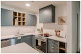Custom vent-hood with quartz backsplash and slide-in range