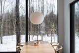 Dining Room, Ceiling Lighting, Chair, and Table  Photo 1 of 50 in In Quebec, a Pair of Black Gables Form a Scandinavian-Inspired Cabin by Construction Memphré