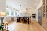 Kitchen, White Cabinet, Medium Hardwood Floor, Refrigerator, Granite Counter, Ceiling Lighting, Subway Tile Backsplashe, Wall Oven, Cooktops, and Range Hood  Photo 10 of 69 in The Farmhouse by the Golf Course by Construction Memphré