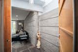 A wood pivot entrance door and 12-in custom concrete walls.