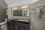 Custom vanity and exposed concrete walls.