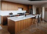 Kitchen, Wood Cabinet, Engineered Quartz Counter, Stone Slab Backsplashe, Range, Range Hood, Refrigerator, Ceiling Lighting, Microwave, and Travertine Floor Renovated kitchen with custom cabinetry  Photo 2 of 9 in Riverside Renovation by Missy Neff