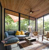 Living Room, Chair, Slate Floor, Sectional, Floor Lighting, End Tables, Coffee Tables, and Sofa  Photo 3 of 23 in An Off-Grid Cabin Wrapped in Glass Hunkers in a Hawaiian Forest from Glass House