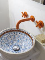 The sink is handmade by a Greek company, Studio Travertino.