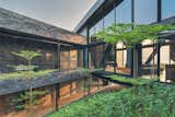 Suspended between the public spaces to the north and the residential block on the south, this metal structure allows for the natural terrain of the ground to flow under it undisturbed