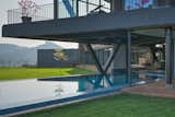 The metal structure cantilevers over the pool making it usable in all climates