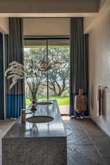 The 100-year-old tree in the background is the hero that is getting framed by the view from this bathroom
