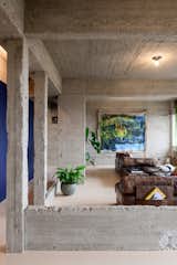 Studio Okami tore down the walls of this five-bedroom apartment and stripped away layers of finishing to reveal beautifully textured concrete.
