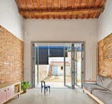 Living Room, Sofa, Concrete Floor, and Console Tables  Photo 5 of 17 in 105JON - Renovation of a row house in the Vallès by Vallribera Arquitectes