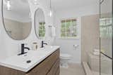 Bath Room, Recessed Lighting, Drop In Sink, Two Piece Toilet, Porcelain Tile Floor, Pendant Lighting, Full Shower, Open Shower, Engineered Quartz Counter, and Ceramic Tile Wall  Photo 10 of 14 in The Ranch Revival by Savannah Gordon