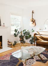 The living room features a musical corner equipt with a guitar and piano.