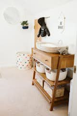 Kids Room, Bedroom Room Type, Light Hardwood Floor, Dresser, Neutral Gender, and Toddler Age Space in the upper hallway makes the perfect diaper changing station for the Gardner's 4 month old son.  Photo 4 of 6 in The Gardner Haus by Alison Gardner