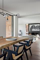 Dining Room, Dark Hardwood Floor, Hanging Fireplace, Table, Chair, and Ceiling Lighting  Photo 6 of 17 in CG House Madrid by Lourdes Martínez Nieto Arquitectura y Diseño