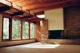 Opening to the left of the entryway is the main living space, featuring 11ft-tall tongue-and-groove ceilings and an enormous fireplace feature constructed of field stone from Jacobsville, Michigan.

On the South wall are four large windows which let in natural light throughout the entire day.

Through the door is the den, a cozy space with low ceilings and its own fireplace similar to—but less grand than—the one shown here. The perfect place to work from home.