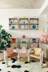 Mikei calls this space the "reading nook," which is complete with six stainless steel shelves from Kiosk48th filled with colorful accessories from Bi-Rite, HAY, MoMA, and DWR. The vintage chairs sit over a rug from Mush Studios.