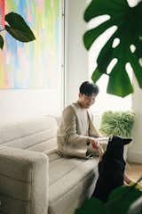 Mikei playing with his dog, Shabu Shabu in the sunny living area. 