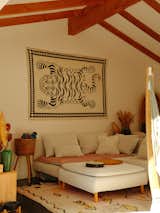 In the living room, a blanket from Mercredi in Bali now hangs over a sofa from Ikea equipped with Bemz's Sergel Skinny Legs. "When we moved down here, we had this giant empty wall and I was like, 'I know what can go here,'" Rachel recalls. The Beni Ourain rug was sourced on Etsy.