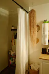 In the bathroom, a custom shower curtain bought from a seller on Etsy named Superior Custom Linens is split in the middle so the couple can enter from the center of the tub.  "Every morning you slide them open and it's like, 'Hello to the day,' says Rachel. 'I don't know why more shower curtains aren't like this. Otherwise you have to clamber in from the side.'