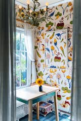 The mural in Kim's kitchen, painted to resemble a wallpaper, is replicated again in the painting on top.  Kim says she was going for a trompe l'oeil effect, "like a painting on a painting on a painting." The furnishings were sourced secondhand from thrift stores and flea markets.