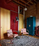 A black and white Angela Adams rug anchors the entryway space, which includes two chairs bought at auction and an Ikea floor lamp.