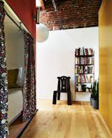 This cozy daybed on the top floor, perfect for guests to rest or read a book, is part of the "tower" that wraps around the staircase. "We wanted to have beautiful things in the house that people could discover, and this daybed was one of them," Eric says.  