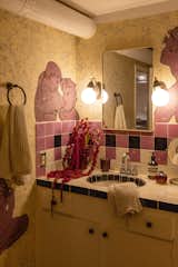 In the bathroom, Thomas (who is also a muralist) painted Jean Cocteau-inspired nudes all over the walls. "I wanted it to feel sexy and elegant and gay and a bit silly,