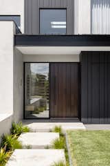 One of the design elements we spent the most time on, believe it or not, was the custom pivot timber entrance door. We choose everything from the width and depth of the grooves to the exact colour of the stain.  It took many people to install it, being so heavy, and it has an electric stripe which means we can enjoy the ease of keyless entry.