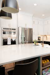 Semi-custom white cabinets up to the ceiling with gold hardware