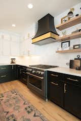Custom range hood in black and gold; select items from Kyndred Shop