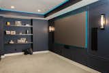 Dark colored walls and blue tone lighting to accent the home entertainment area 
