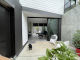 Front patio and entry, with sliding doors open  Photo 13 of 21 in Hillside ADU in Los Angeles Incorporates Steep Terrain Into its Design by Monica Berndt