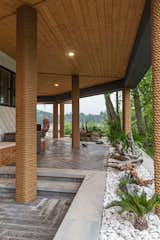 The 360 degree wrap around patio features a tongue and groove ceiling with recessed lighting and pillars wrapped in the same roping used for the bars custom timber swing seating 