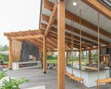 The patio features a stunning custom pergola over the chef grade outdoor kitchen and dining area 