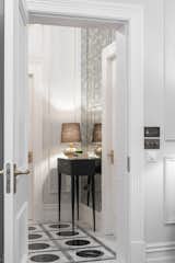 Shot through the entrance hall where a stunning hand cut marble floor & mirrored wall greet you upon arrival. A delicate chest by Ginger & Brown & lamp by Porta Romana finish the total to create a sleek yet refined entrance. 