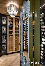 Located at the end of the bar, a display case and humidor is nestled next to a healthy wine collection display wall.