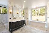 Bath Room, Accent Lighting, Marble Counter, Wall Lighting, Freestanding Tub, Soaking Tub, Marble Floor, Open Shower, Drop In Sink, Recessed Lighting, and Marble Wall  Primary Suite Bathroom   Photo 1 of 23 in Woodstock Zen House by Sheena Lepez