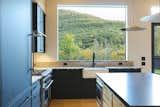 Kitchen, Quartzite Counter, Refrigerator, Microwave, Wood Cabinet, Range, Recessed Lighting, Light Hardwood Floor, Pendant Lighting, Range Hood, and Undermount Sink Kitchen   Photo 4 of 23 in Woodstock Zen House by Sheena Lepez