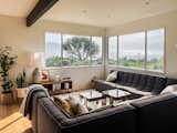 Living room with spacious modern sofa and stunning coastal views