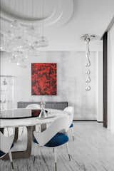 Basement Dining Room with water-inspired custom sculpture and chandelier