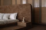 The parent's bedroom features dark Lippan flooring with warm wood accents and varied textures.
