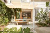 Friche Atelier landscaped the shaded backyard, where an Établi table and Le Balconier chairs cater to alfresco dining.