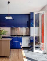 For the kitchen, Eva says, “blue always felt right. I think white kitchens feel a little sterile.”  Photo 4 of 32 in Renovation of brick building by Lisa Baar from In Toronto, a Townhouse Maintains a Punchy Profile While Fitting in With Its Neighbors