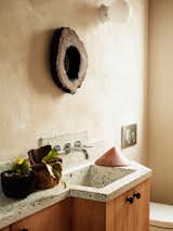 Responsive Homes used the same terrazzo and timber in the powder room as it did in the kitchen.