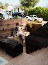 Molly often takes calls by the stairs between the entry and the patio, which she finished in brick by her company, OR.CA, and enclosed with redwood fencing.