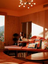 Stephanie sits opposite a turntable left by David. The couple paired it with orange Kanto REN speakers (see top photo). “How could I resist?” asks Pete. The Dracaena Janet Craig Compacta tree is from Easyplant.