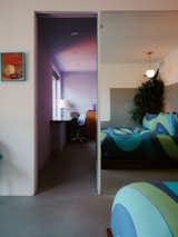 A guest suite on the first floor includes a bedroom, kitchenette, and office area.