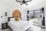Bedroom, Pendant Lighting, Bed, Recessed Lighting, Ceiling Lighting, Carpet Floor, and Night Stands Primary to Backyard  Photo 6 of 9 in The Mariposas Joshua Tree by Ryan Dorough