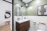 Bath Room, Vessel Sink, Ceramic Tile Wall, Porcelain Tile Floor, and Wall Lighting The 5 piece bathroom also has a metal door with a transom window at the top of the frame.   Photo 8 of 19 in Koi St Clair West by meetmiranda